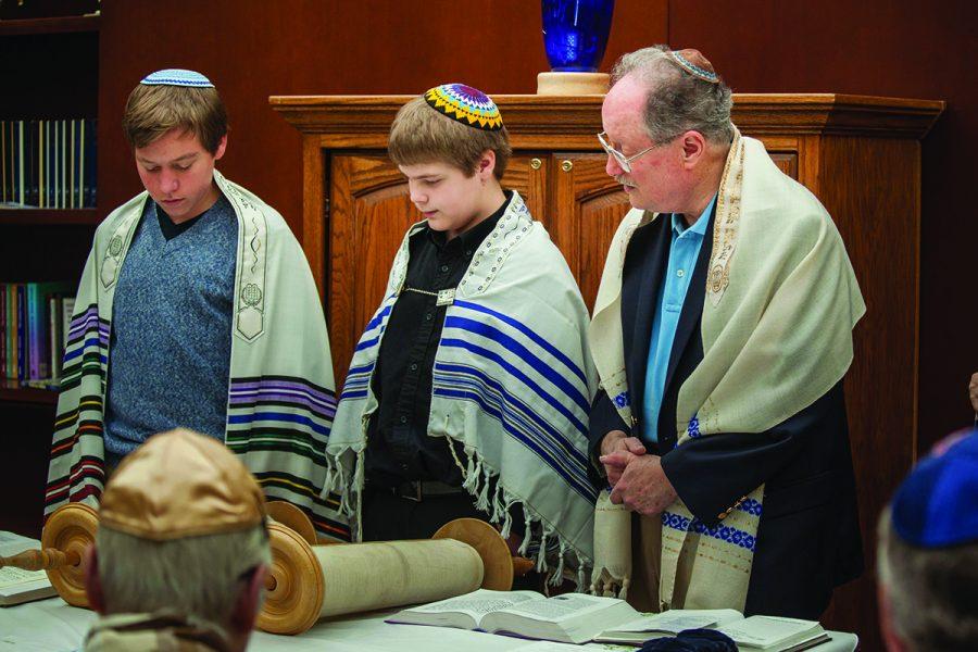 From left, Ryan Bastean, Kyle Bastean, and Rabbi Lane Steinger of Shir Hadash Reconstructionist Community take part in Kyle’s bar mitzvah in April. Photo: Theresa Hudson
