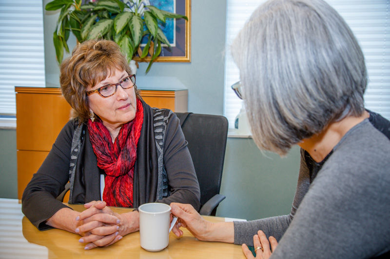 Rabbi Dale Schreiber consults with a family member of a hospice patient. Photo: Kristi Foster