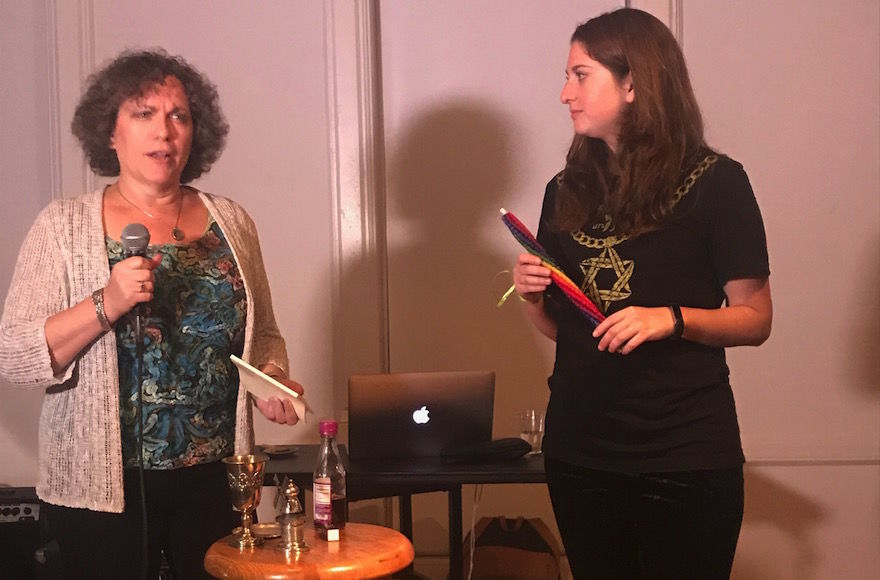 Karen Benezra, left, and Catherine Goldberg leading the havdalah blessings at a recent “Chai Havdalah” event in Brooklyn. (Lucy Cohen Blatter)