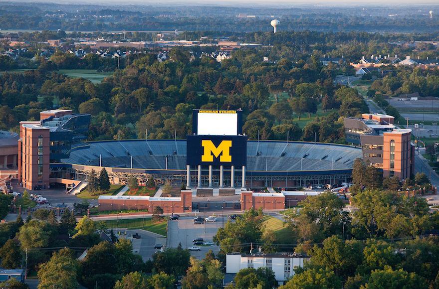 An+aerial+view+of+Michigan+Stadium+as+the+sun+rises+on+the+University+of+Michigan+campus.+%28University+of+Michigan%2FFlickr%29