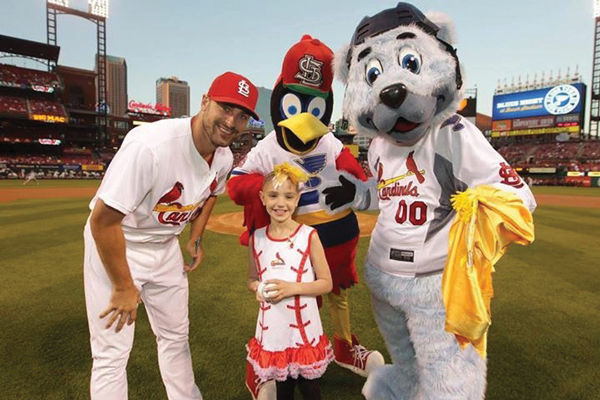 Ari on the field with the St. Louis Cardinals at Busch Stadium.