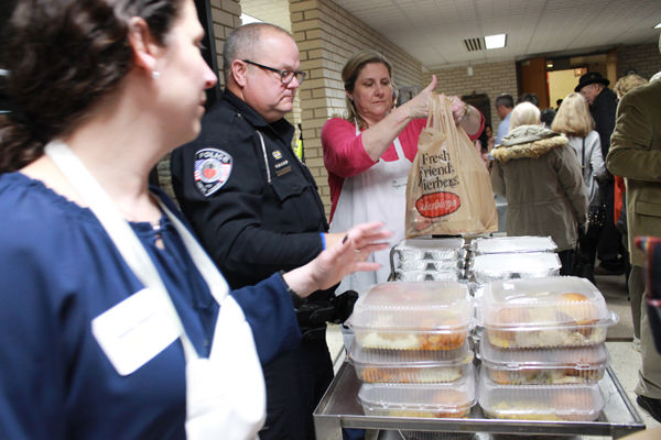 In this file photo, Jayme Fingerman (left) co-chaired Temple Israel's 2017 Thanksgiving Dinner for Those in Need and joined Creve Coeur police officers and volunteers such as Dee Mogerman in packing food for guests.  Photos: Eric Berger