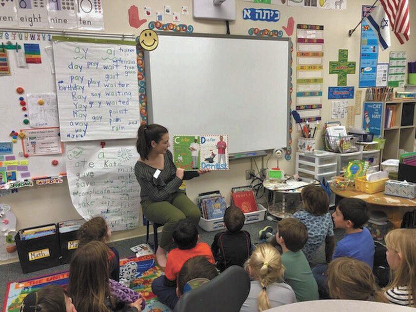 Adina Levy reads to a class at Saul Mirowitz Jewish Community School. Adina discovered her passion for teaching through Spark!, a preprofessional program at Parkway Central High School.