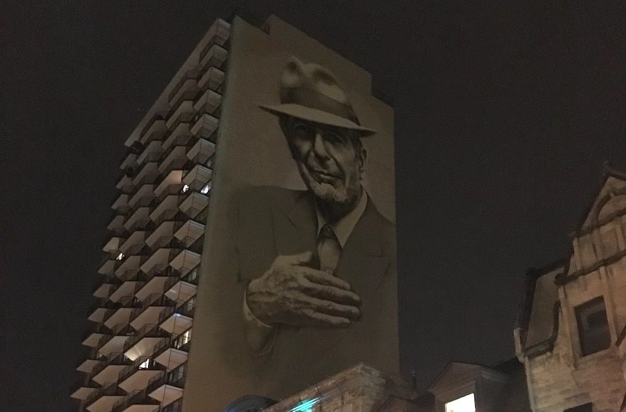 A painting of Leonard Cohen towers above Crescent Street in downtown Montreal. (Ben Harris)