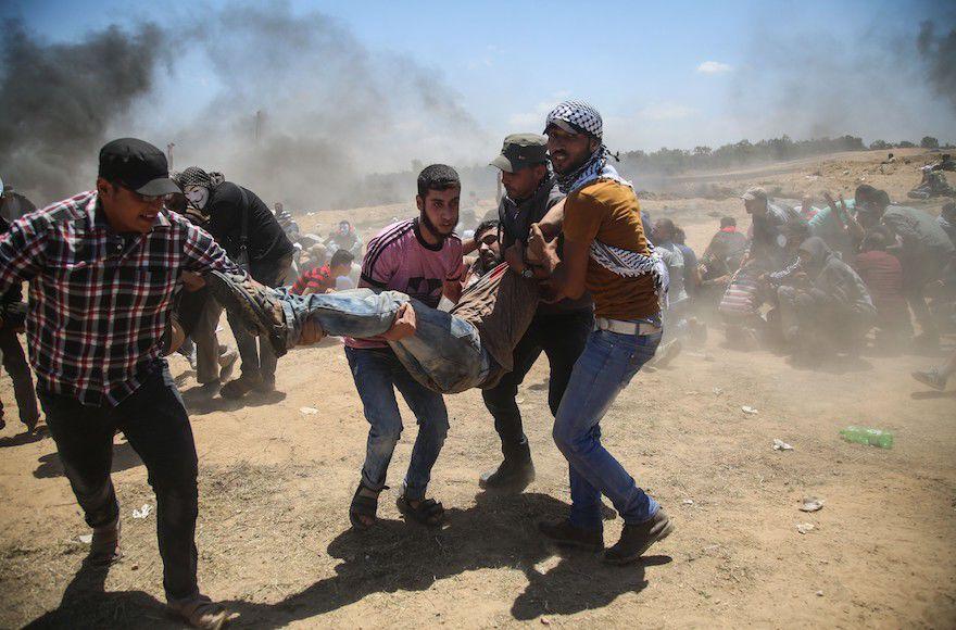 Palestinian protests at Gaza border delayed as funerals take place for at least 58 dead