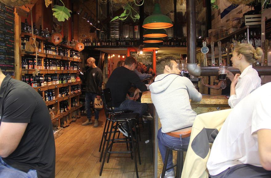 Beer Bazaar, a craft beer shop in Jerusalem’s Mahane Yehuda market, aims to combine the variety of a bazaar with the atmosphere of a chic pub. (Ben Sales)