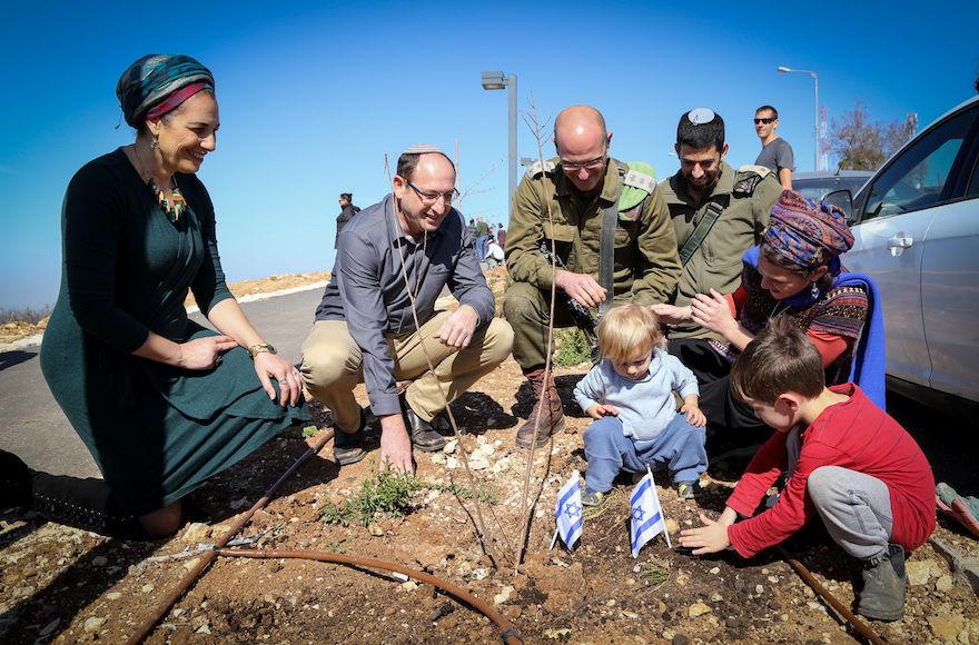 Bat-Galim+and+Ofir+Shaer%2C+left%2C+the+parents+of+slain+Israeli+teenager+Gil-ad+Shaer%2C+plant+trees+in+memory+of+their+son+at+a+West+Bank+kibbutz+with+kids+who+were+named+after+him%2C+Feb.+2%2C+2018.+%28Gershon+Elinson%2FFlash90%29