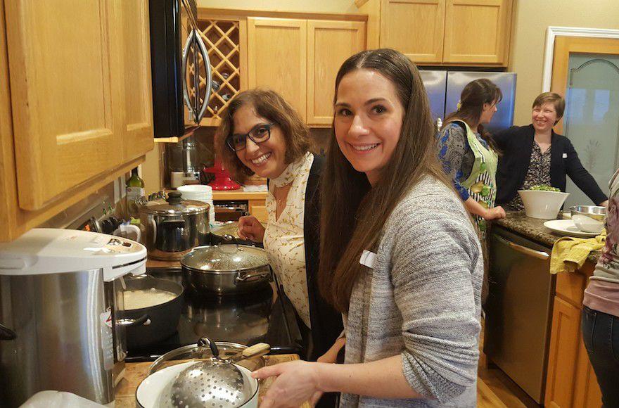 Efi Asaf, left, and Rachel Brown cooking matzah balls at a Mevashlim B’Ivrit class in Boise, Idaho. (Courtesy of Asaf)