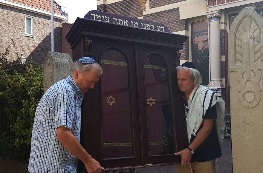 Tom+Furstenberg%2C+right%2C+and+a+fellow+congregant+carrying+the+Torah+ark+out+of+the+Great+Synagogue+of+Deventer%2C+July+30%2C+2018.+%28Cnaan+Liphshiz%29