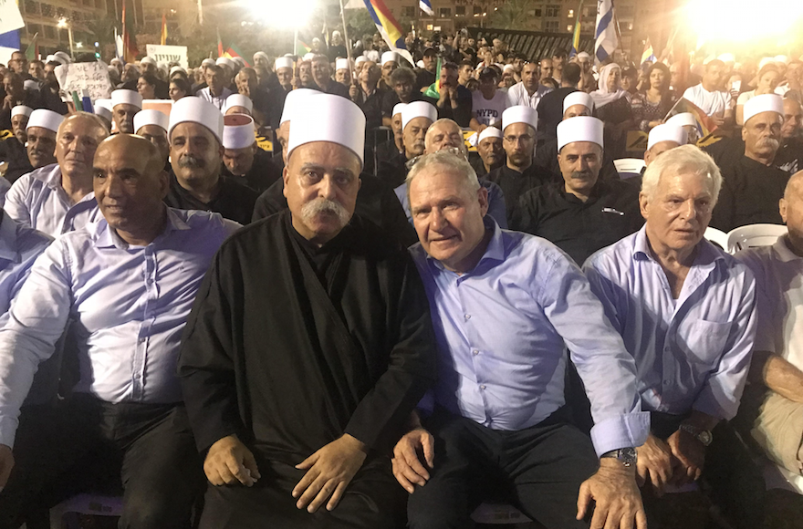 Amos Yadlin, third from left, sits with leaders of Israel’s Druze community at a Tel Aviv rally against the controversial nation-state law, Aug. 5, 2018. (Courtesy of Yadlin)