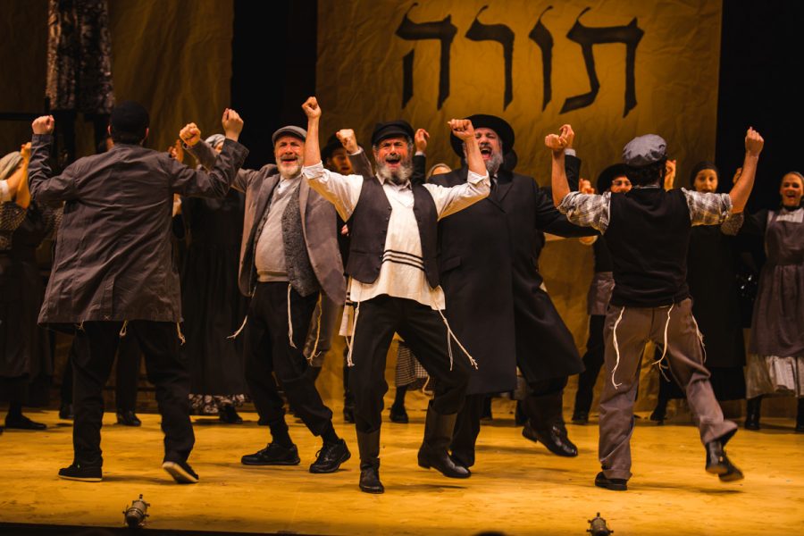 Steven Skybell, as Tevye (center, facing out) in the National Yiddish Theatre Folksbienes Production of Fiddler on the Roof. Photo: Victor Nechay/ProperPix