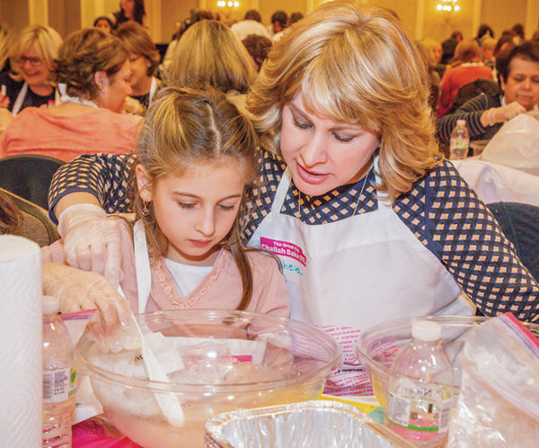 Tehilla and Elisheva Raskas make challah dough during the Great Big Challah Bake of St. Louis on Nov. 10 at the Clayton Plaza Hotel. The event drew close to 500 people. Photo: Kristi Foster