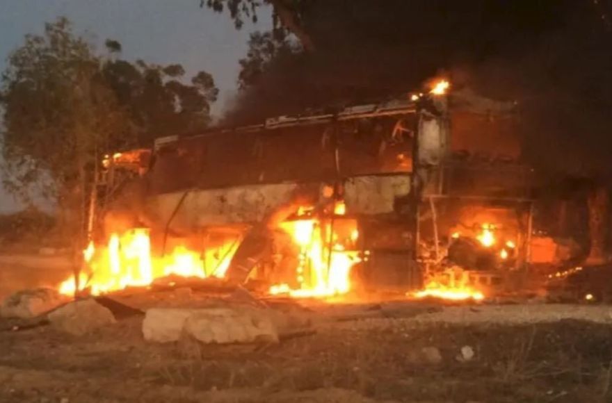 An Israeli bus traveling near the border with Gaza on fire after being hit with Palestinian mortar fire on Nov. 12, 2018. A 19-year-old Israeli man standing next to the bus was seriously injured in the attack. (IDF Spokesperson/Twitter)