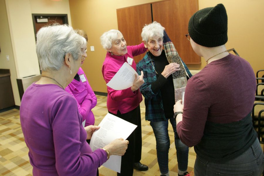 Sharon Shattan places a scarf on Nancy Baum’s shoulder during a small-group acting exercise at a St. Louis NORC drama class in December. Photo: Mike Sherwin