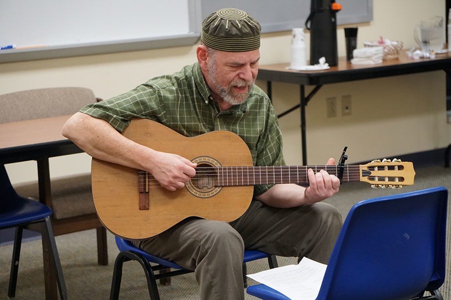 Will Soll teaches a Yiddish version of a Passover song at a Shaare Emeth Yiddish Club meeting.