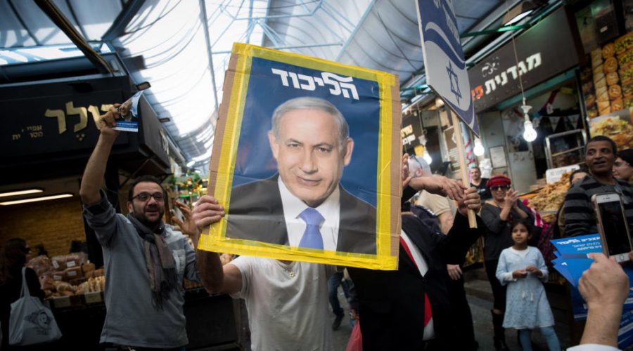 A+Likud+party+supporter+holds+a+picture+of+Israeli+Prime+Minister+Benjamin+Netanyahu+at+the+Mahane+Yehuda+market+in+Jerusalem%2C+April+7%2C+2019.+Photo%3A+Yonatan+Sindel%2FFlash90