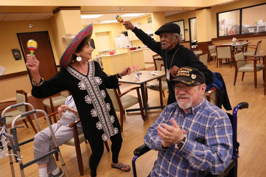 Volunteer Alice Ludmer dances with participants at the J’s Adult Day Center during a Cinco de Mayo celebration. Photo: Bill Motchan