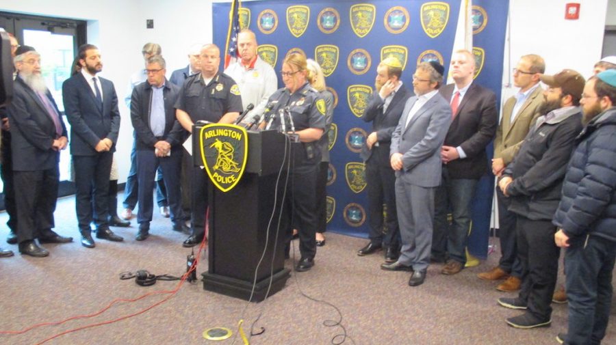 Julie Flaherty, acting police chief of Arlington, Mass., addresses a news conference at the towns police station as Rabbi Avi Bukiet, second from left, looks on, May 17, 2019. (Penny Schwartz)