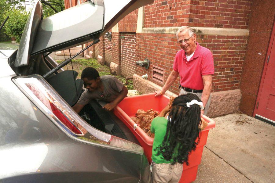 Students at Monroe Elementary School in St. Louis city help Dr. Terry Weiss unload his weekly delivery of food from Operation Food Search. Photo: Bill Motchan