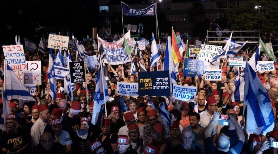 Tens+of+thousands+of+Israelis+demonstrate+in+an+opposition+rally+dubbed+Defensive+Shield+For+Democracy+in+Tel+Aviv+in+protest+of+proposed+legislation+aimed+at+giving+immunity+from+prosecution+for+members+of+the+Knesset%2C+including+Prime+Minister+Benjamin+Netanyahu.+Photo%3A+Tomer+Neuberg%2FFlash90