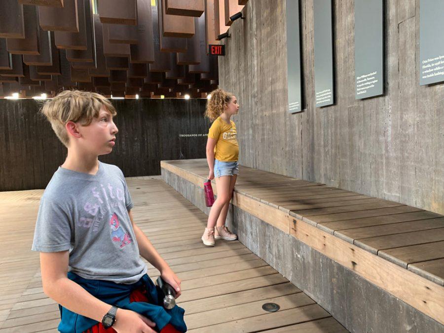 Saul Mirowitz Jewish Community School eighth grader Omry Kielmanowitz and sixth grader Leora Dean visit the Legacy Museum’s lynching memorial in Montgomery, Ala. In the background, 800 steel monuments suspended from the ceiling represent counties in the U.S. where a lynching took place.