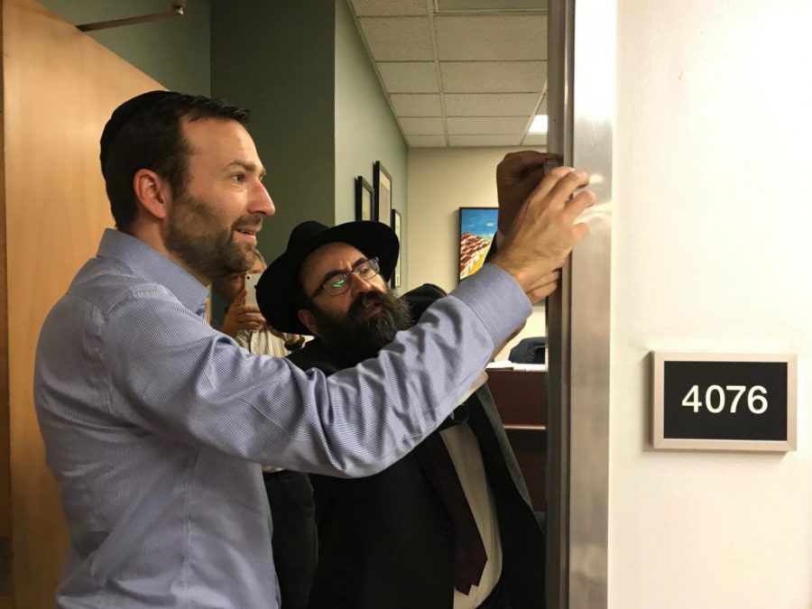 California State Sen. Ben Allen, chair of the Jewish Caucus, puts a mezuzah on his office door with Rabbi Mendy Cohen. Photo Courtesy of the Jewish Caucus