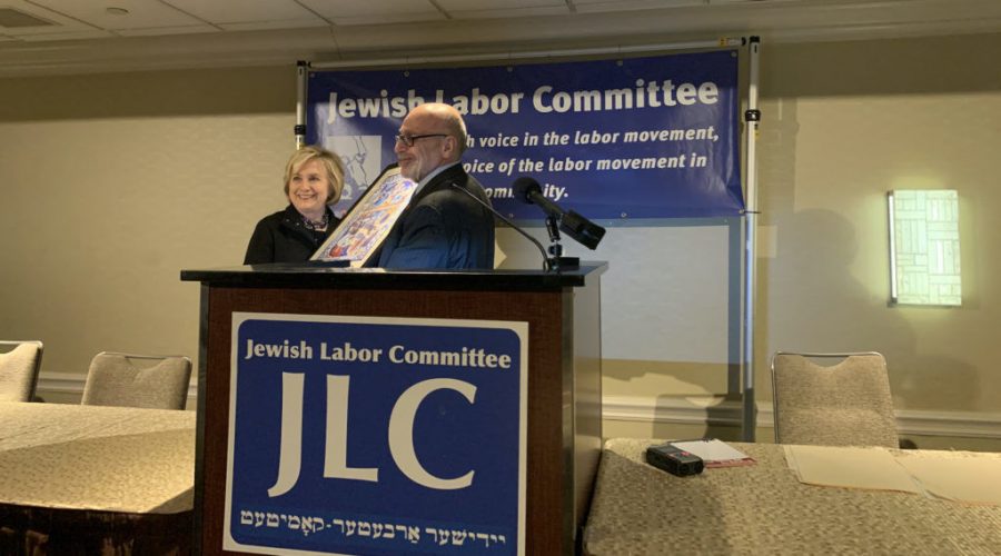 Jewish+Labor+Committee+President+Stuart+Appelbaum+presenting+Hillary+Clinton+with+a+poster+portraying+the+Jewish+immigrant+experience+in+the+U.S.+at+the+Sheraton+New+York+Times+Square+Hotel%2C+Dec.+9%2C+2019.+%28Josefin+Dolsten%29