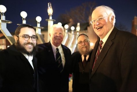 From left to right, Rabbi Chaim Landa, St. Charles Mayor Dan Borgmeyer, Rabbi Yosef Landa and St. Charles County Executive Steve Ehlmann take part in a menorah lighting ceremony in St. Charles on the first night of Hanukkah. At the event, Chabad announced it will start a new branch to serve Jews in St. Charles. Photo: Bill Motchan