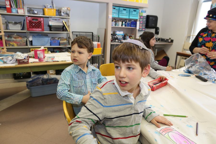 Epstein Hebrew Academy students Ezra Cohen (left) and Jack Wertman take in an art class led by Morah Baila Shulman at right. 