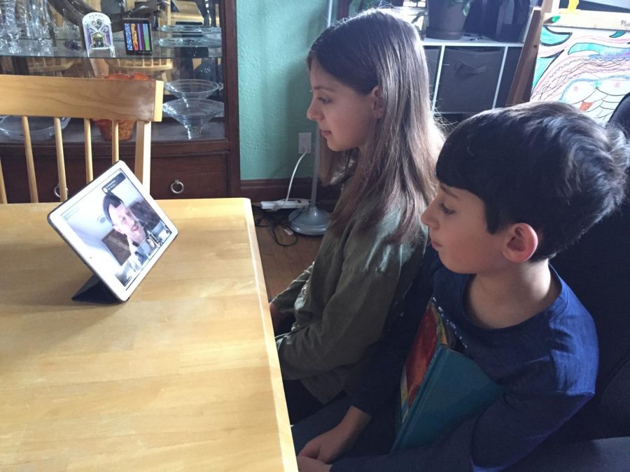 At left, Saul Mirowitz Jewish Community School students Eliana and Gabriel Wax participate in the online morning tefillah service led by Rabbi Scott Slarskey through Zoom.  