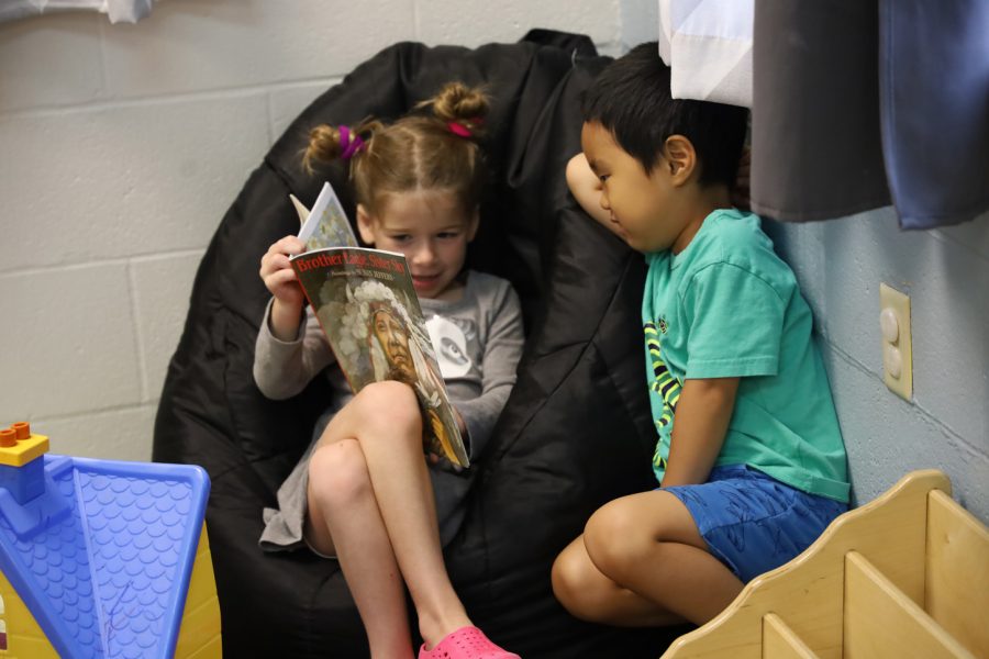 Children look through a book at the Js Early Childhood Center at the Marilyn Fox Building.