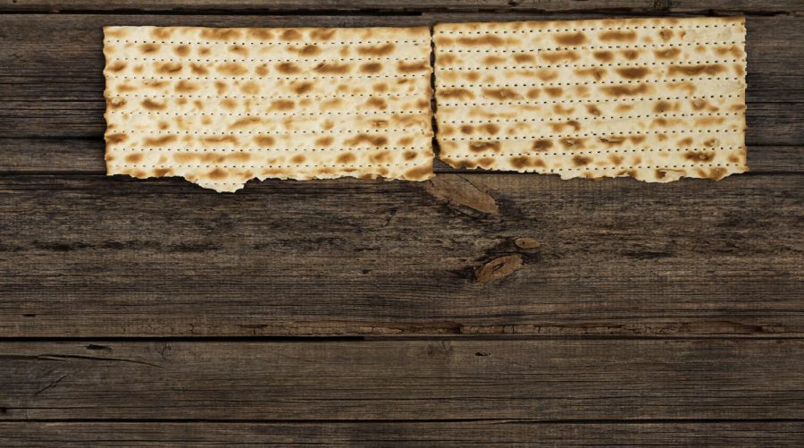Four pieces of matzah or matza on a vintage wood background with copy space or text space. Perfect for your Passover design.