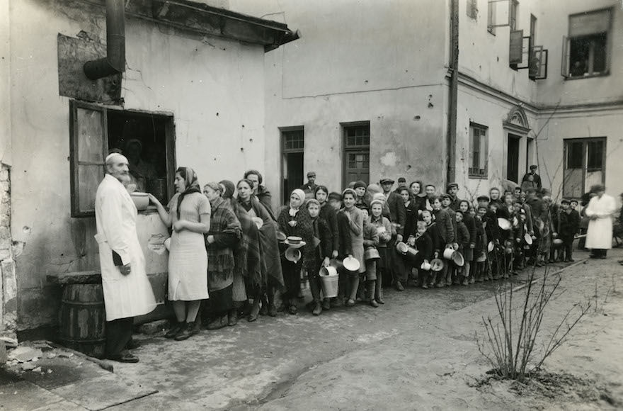 Jews lined up in the Warsaw Ghetto during World War II. (Courtesy of American Jewish Joint Distribution Committee Archives)
