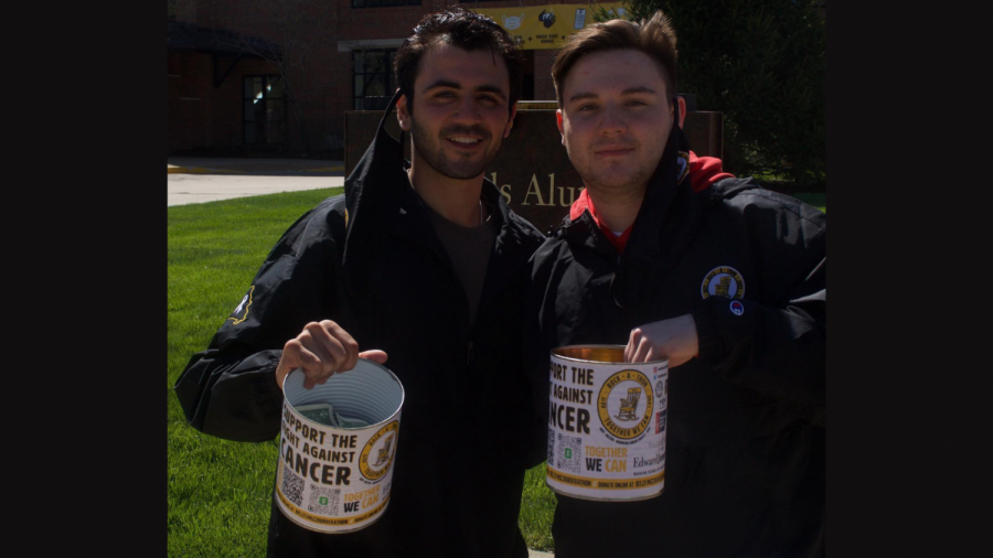 Fraternity members (from left) Josh Max and Michael Balk pose while canning in the streets of downtown Columbia, MO (AEPi Rock-A-Thon, Facebook)