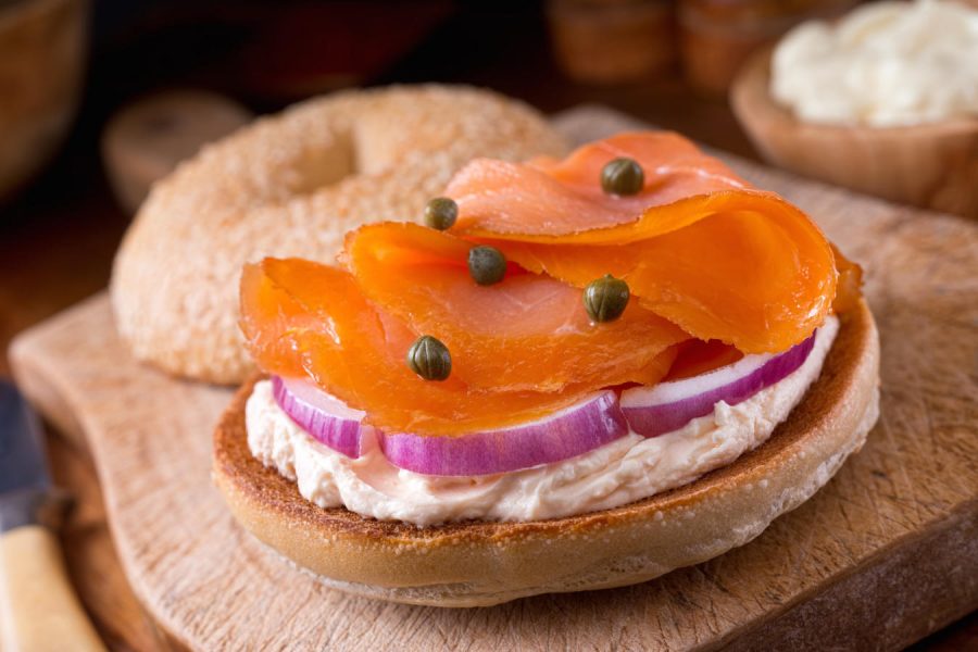 A delicious homemade toasted sesame seed bagel with smoked salmon, whipped cream cheese, red onion, and capers.