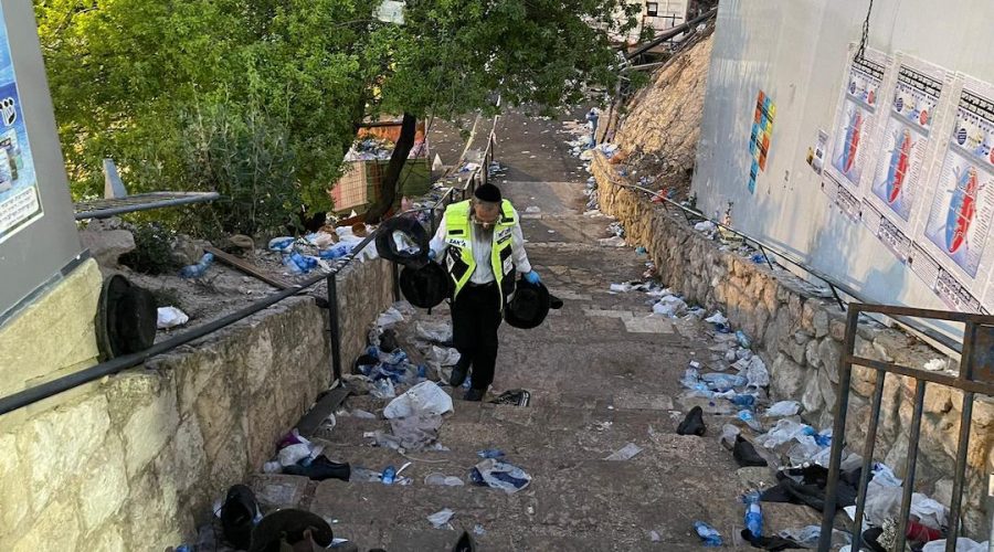 A volunteer with the ZAKA response group walks through the debris left in the aftermath of the stampede in Meron, Israel, April 30, 2021. (ZAKA/Aharon Baruch Leibowitz)