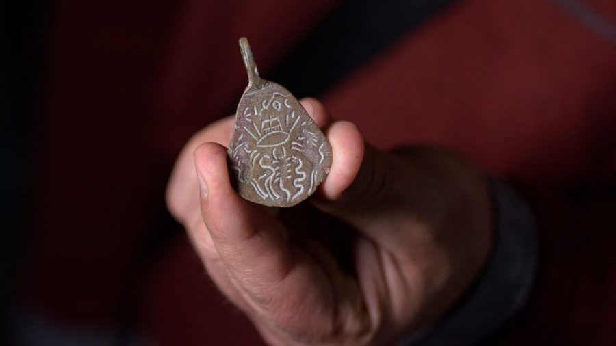 The reverse side of an ancient bronze amulet found near the ruins of the Arbel synagogue in northern Israel depicts protection against the evil eye. Photo by Dafna Gazit/Israel Antiquities Authority
