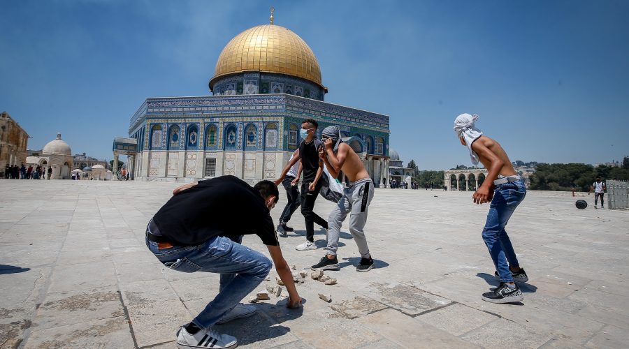 Palestinian worshippers gather rocks to throw at the Al-Aqsa mosque compound in Jerusalems Old City, June 18, 2021. (Jamal Awad/Flash90)