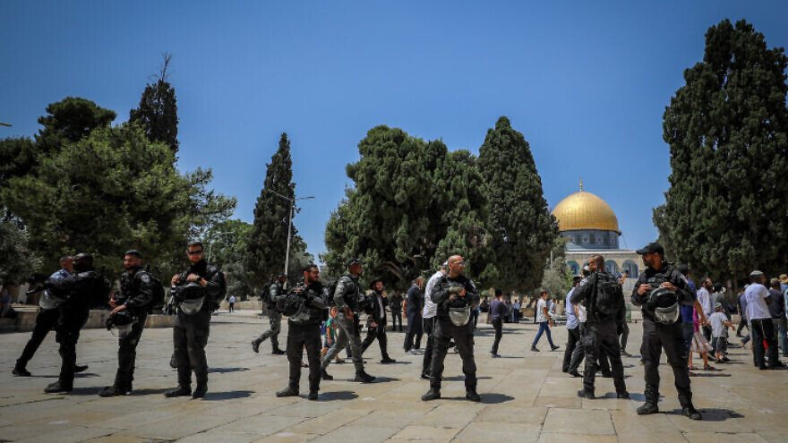 Israeli security forces guard as a group of religious Jews visit the Temple Mount, also known as Haram al Sharif, in Jerusalems Old City, during Tisha Bav, July 18, 2021. Photo by Jamal Awad/Flash90
