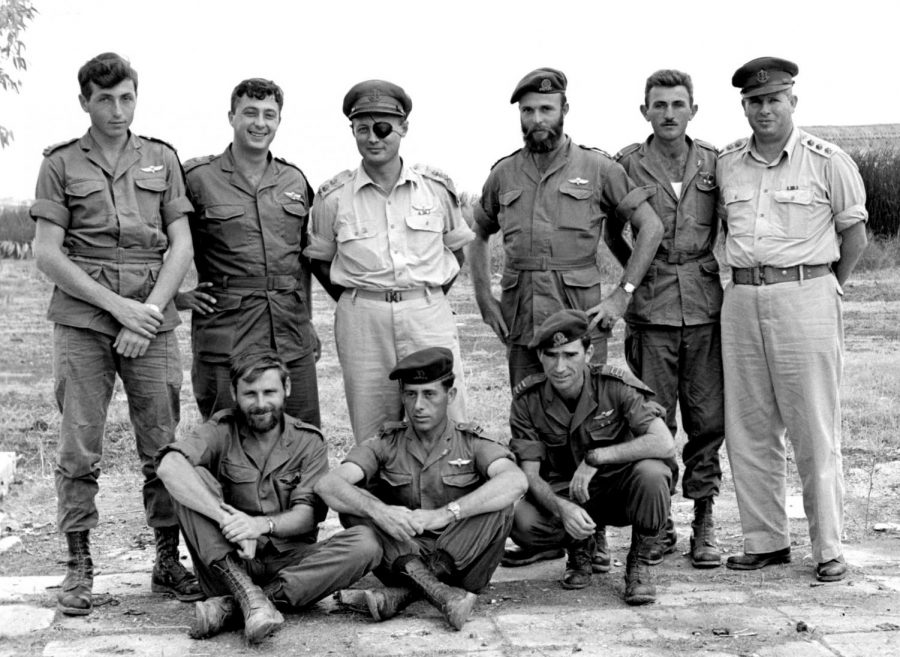 AUG. 5: Members of Unit 101, including Ariel Sharon (standing, second from left), pose with Moshe Dayan after a successful operation in 1955, by which time the unit was part of the Paratroopers Brigade instead of an independent force. Dayan had opposed Unit 101’s creation in 1953. Photo: IDF Spokesperson’s Unit