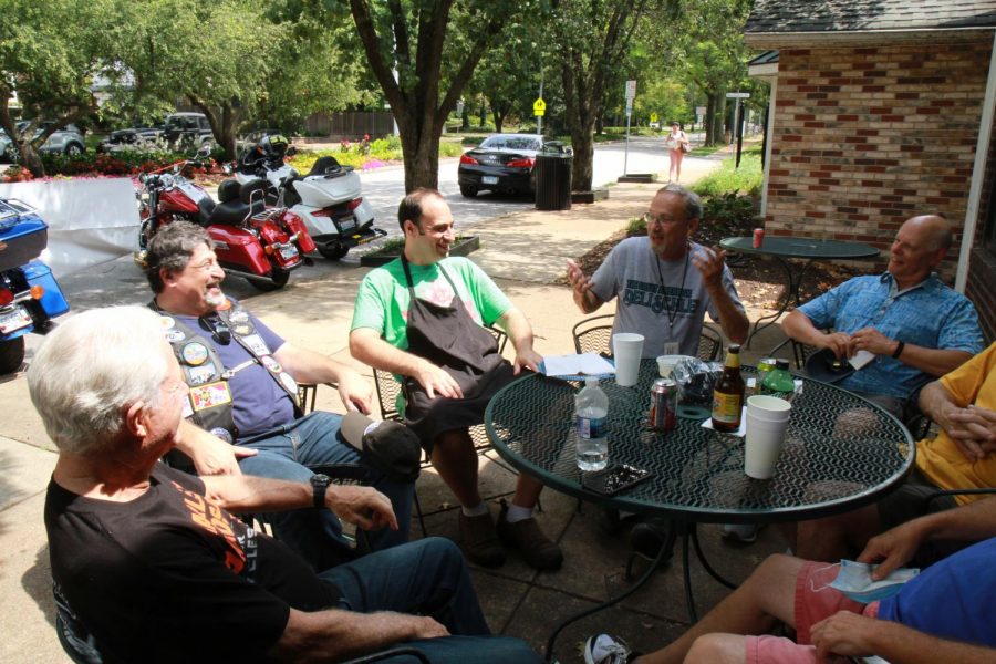 On Friday, Aug. 13 at Protzel’s Delicatessen in Clayton, Steve Goode (gray The Great American Deli Schlep shirt) talks with the deli owner, Max Protzel (green shirt, apron), motorcyclist Steven Aroesty (vest with patches) and other Jewish riders. 