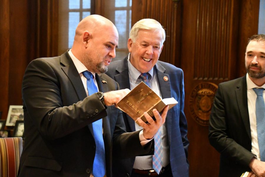 Maor Elbaz-Starinsky, (left) the consul general of Israel in Miami, presents Gov. Mike Parson with a copy of the Torah on Thursday, Oct. 28 in Missouri. (Photo from Gov. Mike Parsons Twitter feed.)