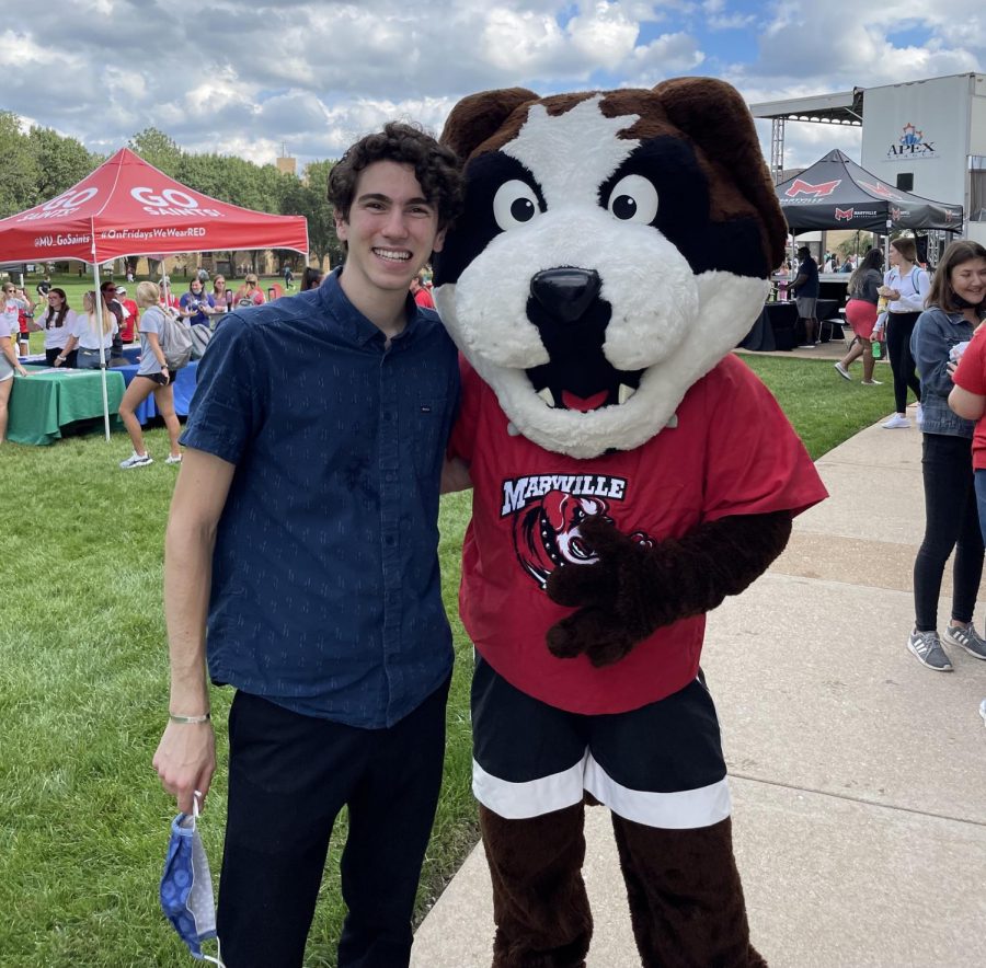 Joey Abeles, the new manager of the Maryville University Hillel, stands with the school mascot, Louie.
