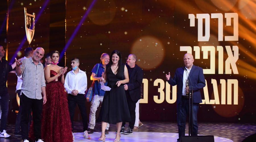 Director Eran Kolirin, far left, and cast members of Let It Be Morning, receive an award at the Ophir Awards, Israels Oscars equivalent, in Tel Aviv, Oct. 5, 2021. (Tomer Neuberg/Flash90)