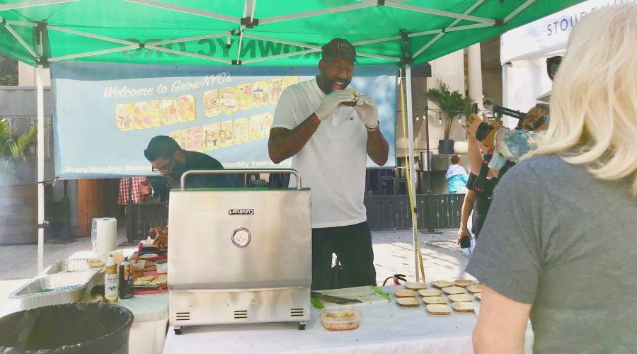 Amare Stoudemire, assistant coach of the Brooklyn Nets, samples one of his own signature Stoudemire Farms burgers at his booth at the Union Square Greenmarket in Manhattan, Oct. 15, 2021. (Julia Gergely)