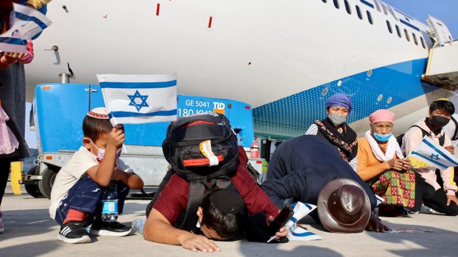New Bnei Menashe immigrants kissing the ground after arriving in Israel on October 13, 2021. Photo by Laura Ben David/Shavei Israel