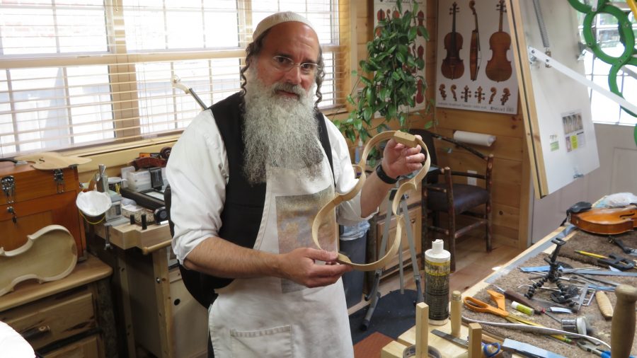 Zev Zalman Ludwick, once a denizen of the heavy metal music scene, poses in his luthier studio in Silver Spring, Maryland on May 23, 2021. (Ron Kampeas)