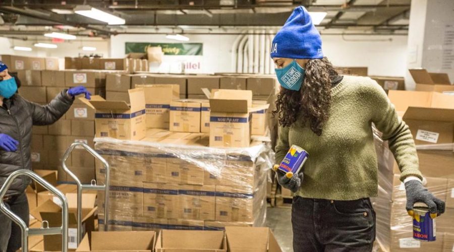 A volunteer helps package emergency food deliveries for Holocaust survivors at the Greenpoint, Brooklyn Fulfillment Center of the Metropolitan Council on Jewish Poverty, a beneficiary agency of the UJA-Federation of New York, Jan. 18, 2021. (Met Council)