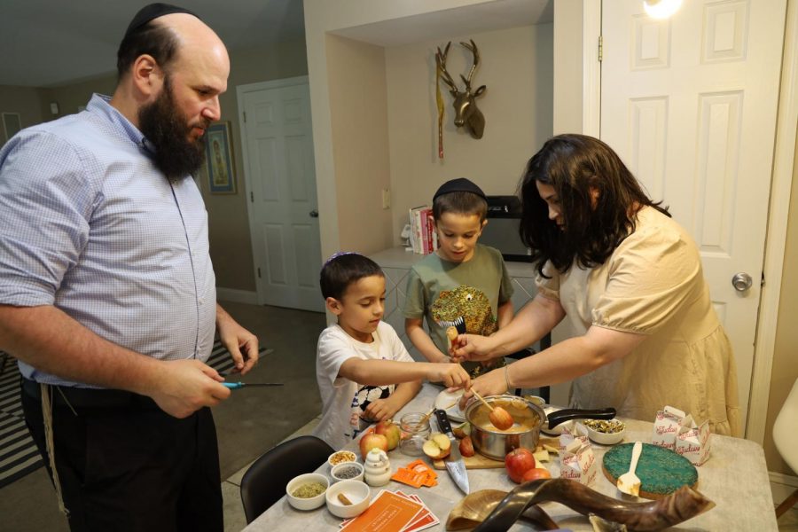 Rabbi+Avi+and+Chanala+Rubenfeld+at+home+with+their+children+Benny+and+Dovi+in+a+2020+photo.+Photo%3A+Bill+Motchan