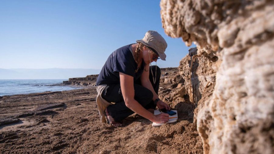 The University of Haifa’s Dr. Beverly Goodman examines soil layers exposed by the retreat of the Dead Sea. Photo by Hagai Nativ/Morris Kahn Marine Research Station of University of Haifa